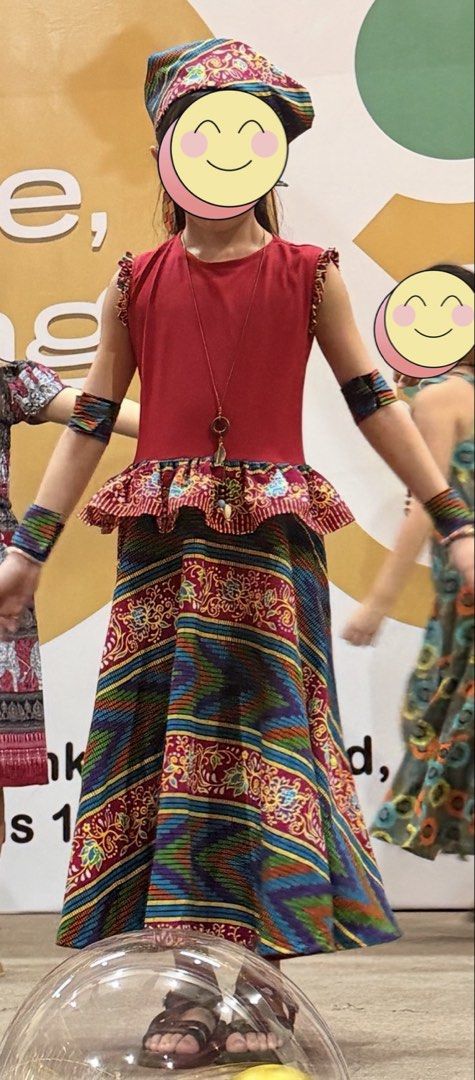 African Costume Set (Category: Babies & Kids Fashion) located in Quezon City. Submitted by frappes (Listing ID 1469441761, Image 2). Description: - Set includes: Red top, colorful patterned skirt, matching headscarf, and 4 arm cuffs - Condition: Worn only once for a performance - Features: Beautiful detailing around the shoulders and waist peplum - Perfect for: Stage shows, cultural events, or school dress-up days - Bright and eye-catching colors