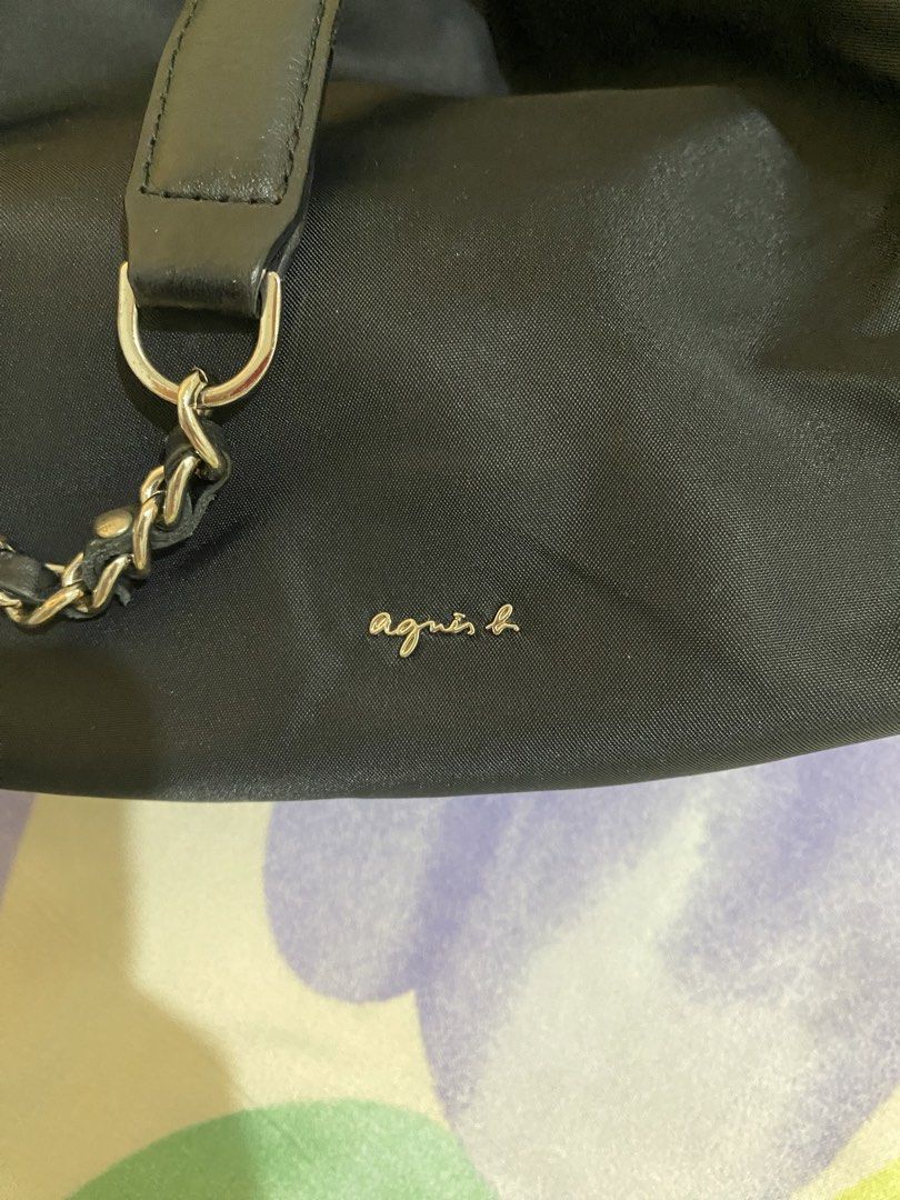 Agnes b. Black Nylon Bucket Bag with Chain Strap (Category: Shoulder Bags) located in Paranaque City. Submitted by chelleann12 (Listing ID 1469442301, Image 3). Description: - Brand: Agnes b. - Material: Lightweight black nylon - Closure: Drawstring top - Hardware: Gold-tone logo lettering - Strap: Chain strap with leather shoulder guard for added comfort - Storage: Convenient side pockets included - Style: Versatile and easy to match with any da