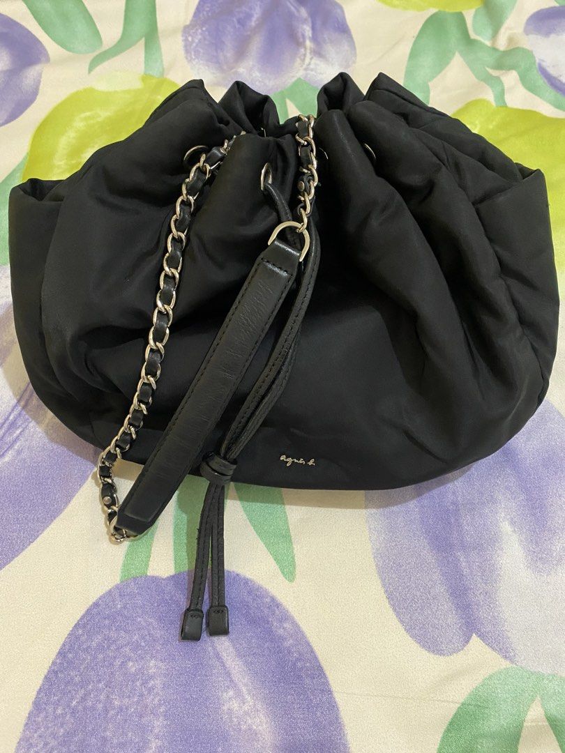 Agnes b. Black Nylon Bucket Bag with Chain Strap (Category: Shoulder Bags) located in Paranaque City. Submitted by chelleann12 (Listing ID 1469442301, Image 2). Description: - Brand: Agnes b. - Material: Lightweight black nylon - Closure: Drawstring top - Hardware: Gold-tone logo lettering - Strap: Chain strap with leather shoulder guard for added comfort - Storage: Convenient side pockets included - Style: Versatile and easy to match with any da