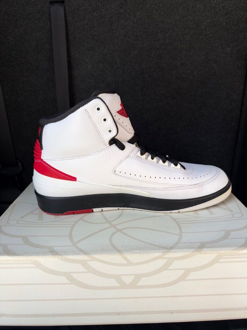 Air Jordan 2 Chicago (Category: Sneakers) located in Caloocan City. Submitted by luckydeer_4f53ea (Listing ID 1469441850, Image 3). Description: - Model: Air Jordan 2 Retro - Colorway: White, Black, and Red - Design: High-top silhouette with classic leather and premium faux-lizard skin texture panels - Features: Perforated toe box, Nike branded heel tabs, and sleek black midsole - Condition: Used with original box included - Mode of Payment: GCas