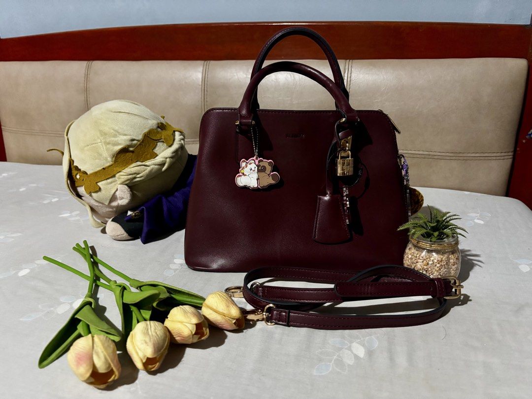 ALBERTO Maroon Handbag with Detachable Strap (Category: Shoulder Bags) located in Manila. Submitted by cleverdog_2c1729 (Listing ID 1469513188, Image 1). Description: - Brand: ALBERTO - Color: Maroon - Includes matching adjustable shoulder strap and cute character keychain - Secure main zipped compartment flanked by two open side sections with magnetic snap closures - Interior lining features printed ALBERTO branding - Elegant gold-tone hardware 
