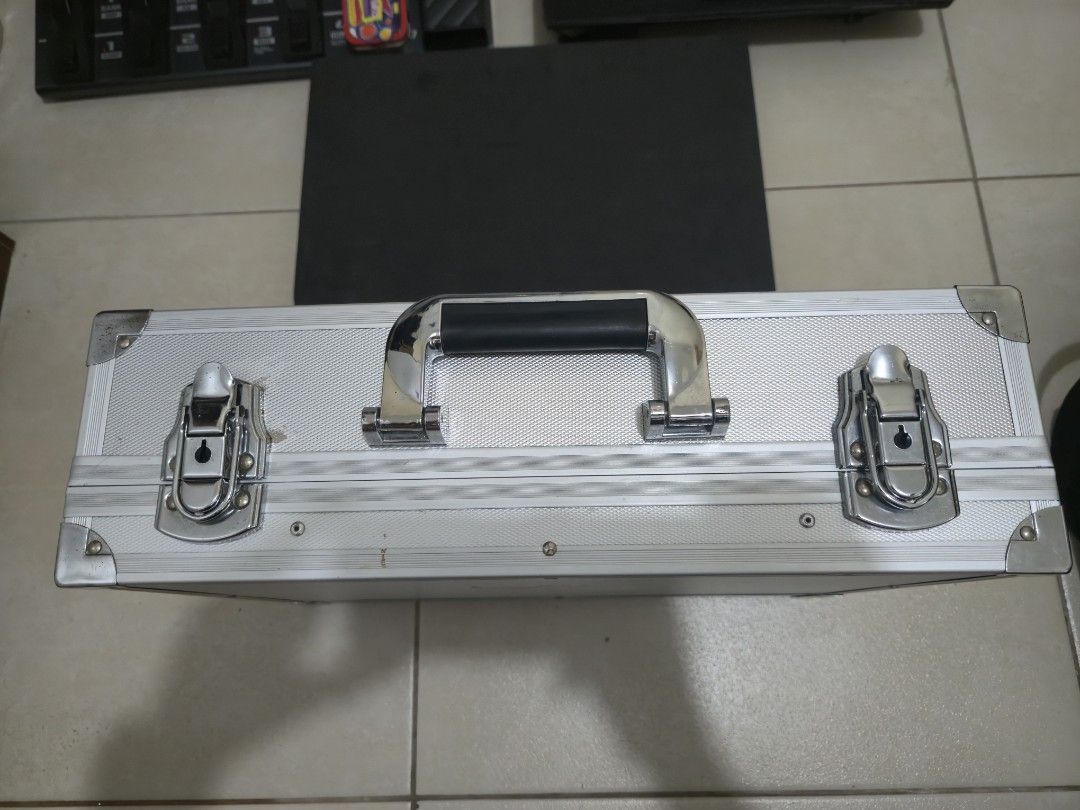 Aluminum Guitar Pedalboard Case with Foam Padding (Category: Musical Instruments) located in Makati City. Submitted by nategz (Listing ID 1469408499, Image 2). Description: - Size: Measures approximately 16 inches long - Material: Sturdy aluminum exterior with secure metal latches - Interior: Lined with dark foam padding to keep gear secure and scratch-free - Portability: Features a comfortable rubber handle for easy transport - Condition: Clean 