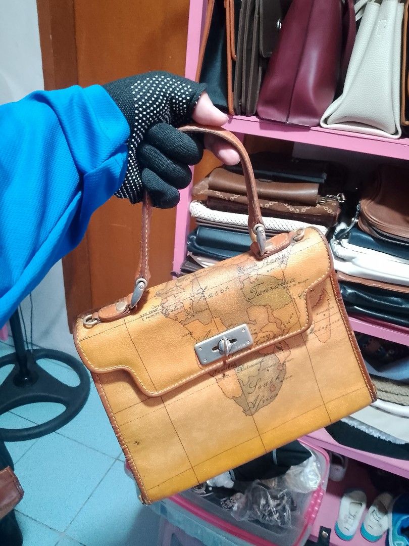 Alviero Martini 1A Classe Geo Map Handbag (Category: Luxury Bags & Wallets) located in Manila. Submitted by romeoamoro00044 (Listing ID 1469492828, Image 1). Description: - Authentic Alviero Martini 1A Classe handbag - Iconic all-over vintage map print with elegant tan leather trim - Dual top handles for comfortable carrying - Secure metal turn-lock closure on the front flap - Spacious main compartment with pink interior lining - Includes an inte