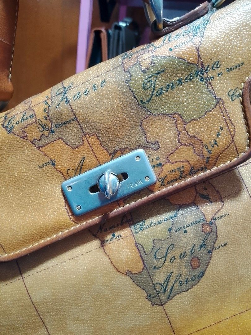 Alviero Martini 1A Classe Geo Map Handbag (Category: Luxury Bags & Wallets) located in Manila. Submitted by romeoamoro00044 (Listing ID 1469492828, Image 2). Description: - Authentic Alviero Martini 1A Classe handbag - Iconic all-over vintage map print with elegant tan leather trim - Dual top handles for comfortable carrying - Secure metal turn-lock closure on the front flap - Spacious main compartment with pink interior lining - Includes an inte