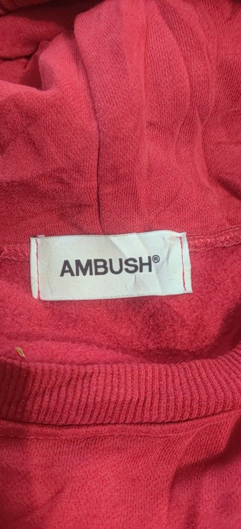 AMBUSH Red Multi-Drawstring Hoodie Size 1 (Category: Hoodies) located in Bago City. Submitted by louielinco (Listing ID 1469437302, Image 2). Description: - Brand: Ambush - Color: Red with white logo text - Size: 1 (Made in Japan) - Material: 100% premium cotton - Details: Distinctive multi-colored braided drawstrings with branded metal aglets and center lock hardware - Features: Standard kangaroo pocket construction - Condition: Interior care ta