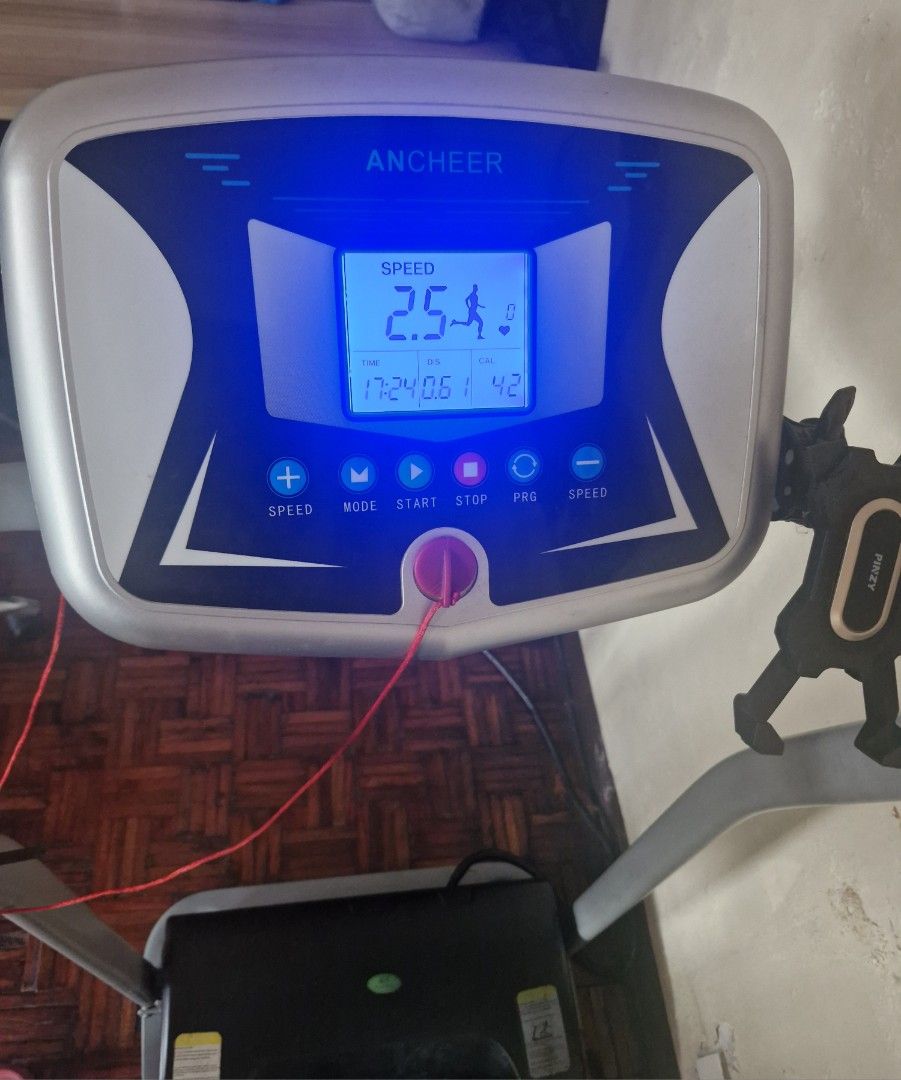 ANCHEER Electric Treadmill with Digital Display (Category: Cardio & Fitness Machines) located in San Juan City. Submitted by lss88 (Listing ID 1469400336, Image 2). Description: - Brand: ANCHEER - Color: Grey and Black - Display: Digital LED showing speed, time, distance, and calories - Features: Includes safety key and convenient phone mount - Design: Compact, folding treadmill ideal for indoor walking and running.