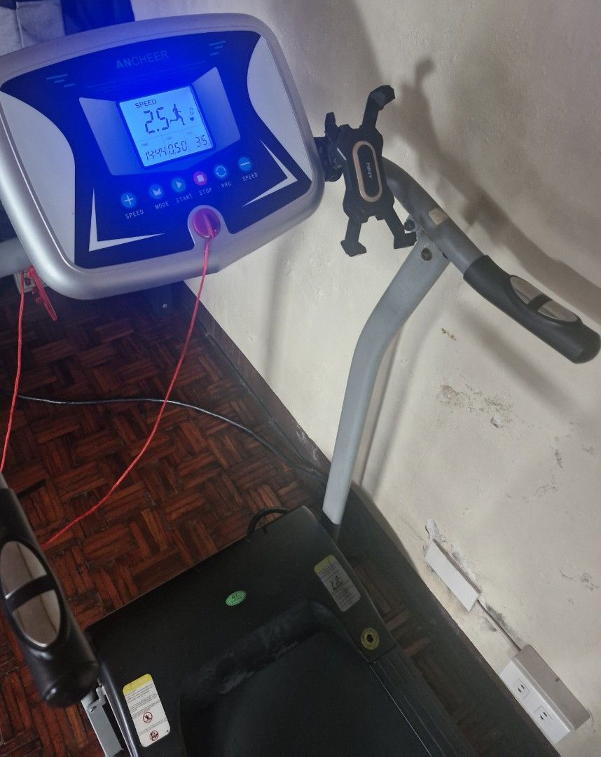 ANCHEER Electric Treadmill with Digital Display (Category: Cardio & Fitness Machines) located in San Juan City. Submitted by lss88 (Listing ID 1469400336, Image 3). Description: - Brand: ANCHEER - Color: Grey and Black - Display: Digital LED showing speed, time, distance, and calories - Features: Includes safety key and convenient phone mount - Design: Compact, folding treadmill ideal for indoor walking and running.
