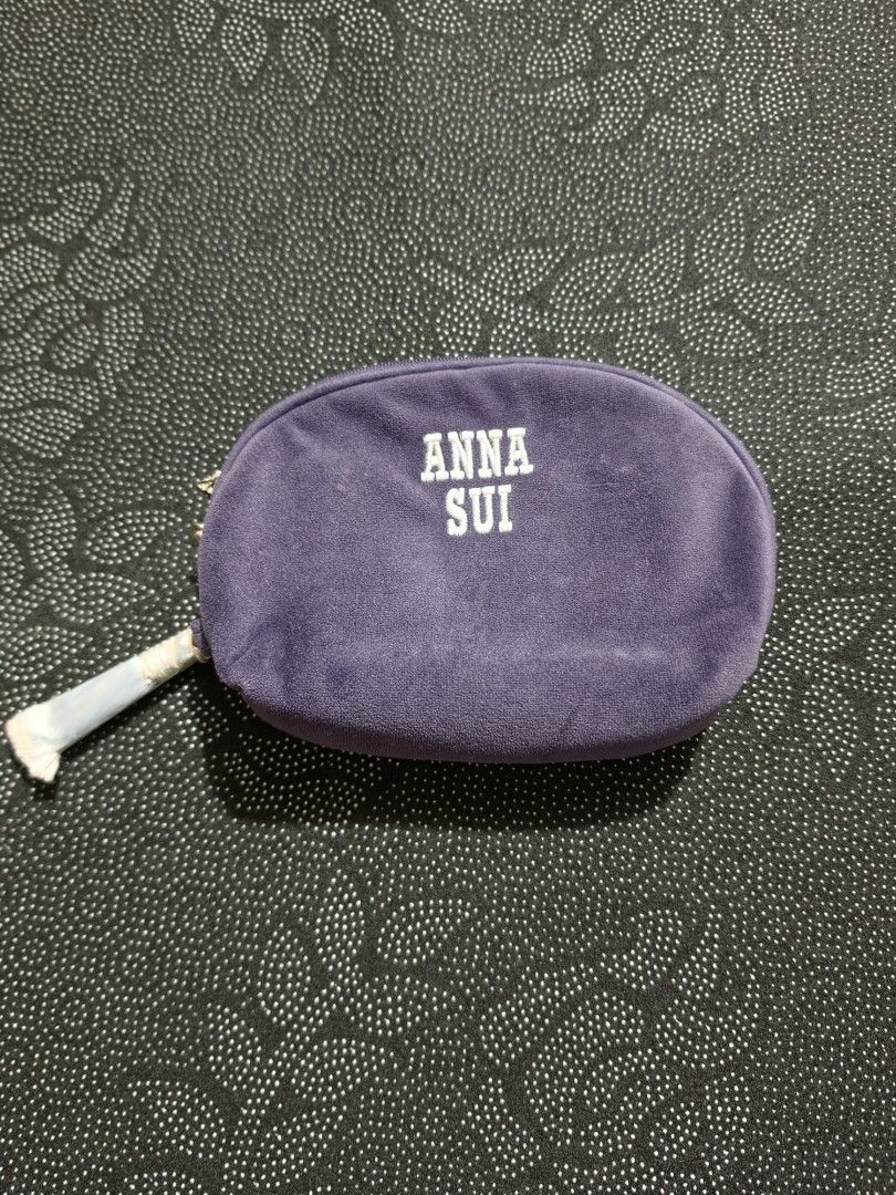 Anna Sui Purple Cosmetic Pouch (Category: Purses & Pouches) located in Manila. Submitted by gentlewind_91c54e (Listing ID 1469532413, Image 1). Description: - Brand: Anna Sui - Color: Purple with white embroidered logo - Closure: Double zip (protective plastic still on one pull tab) - Interior: Light blue fabric lining with pockets and slip compartments - Condition: Good exterior, with some stains and marks inside the lining from previous use - S