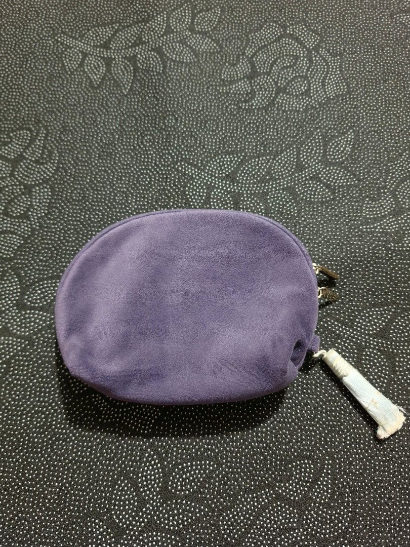 Anna Sui Purple Cosmetic Pouch (Category: Purses & Pouches) located in Manila. Submitted by gentlewind_91c54e (Listing ID 1469532413, Image 3). Description: - Brand: Anna Sui - Color: Purple with white embroidered logo - Closure: Double zip (protective plastic still on one pull tab) - Interior: Light blue fabric lining with pockets and slip compartments - Condition: Good exterior, with some stains and marks inside the lining from previous use - S