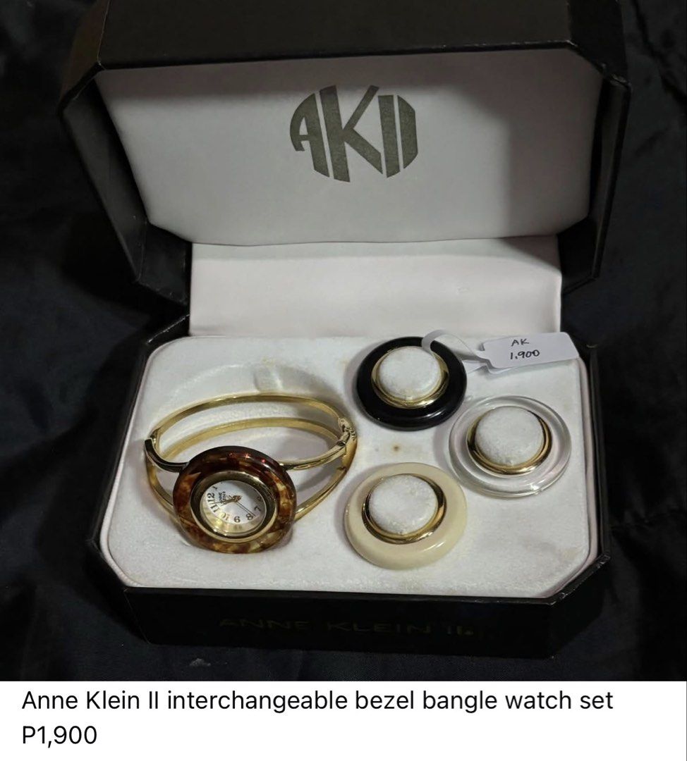Anne Klein II Interchangeable Bezel Bangle Watch Set (Category: Women's Watches) located in Caloocan City. Submitted by berndale_closet (Listing ID 1469569670, Image 1). Description: - Brand: Anne Klein II - Style: Gold-tone bangle watch with quartz movement and Hong Kong mechanism - Versatility: Includes 4 interchangeable bezels (tortoiseshell, black, cream, and clear) - Dial: Classic white round dial with easy-to-read black numerals - Materials