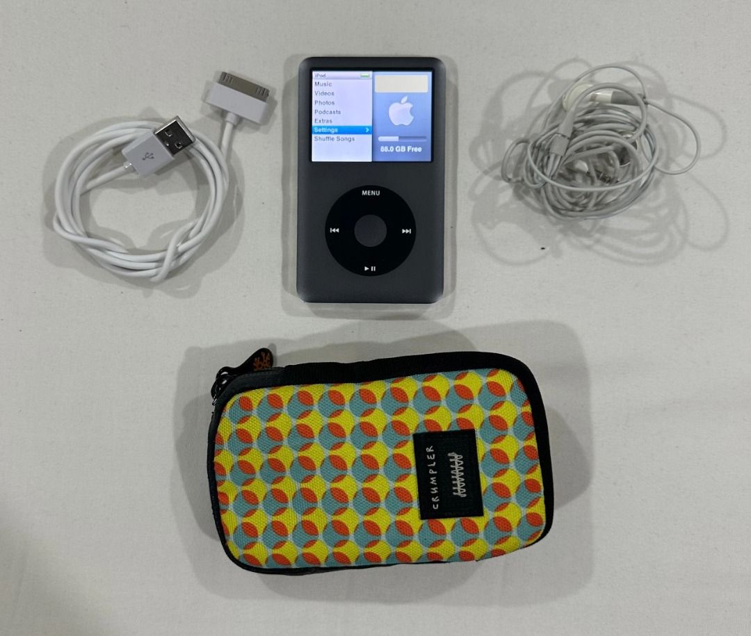Apple iPod Classic 160GB Silver with Accessories and Case (Category: Portable Music Players) located in San Juan City. Submitted by looneyc (Listing ID 1469437217, Image 2). Description: - Model: Apple iPod Classic (160GB, Dark Grey Silver) - Condition: Fully working, screen turns on clearly, charges normally - Flaws: Minor scratches on the chrome back panel from normal use - Inclusions: 30-pin USB sync charging cable, wired Apple earphones, and 