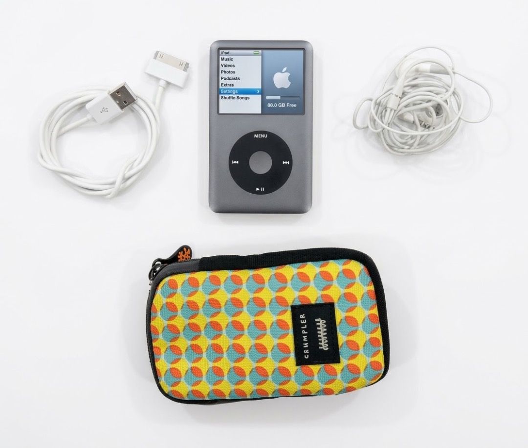 Apple iPod Classic 160GB with Case (Category: Portable Music Players) located in San Juan City. Submitted by looneybin559 (Listing ID 1469438313, Image 1). Description: - Model: Apple iPod Classic (160GB, Dark Grey Silver) - Condition: Fully working, screen turns on clearly, charges normally - Flaws: Minor scratches on the chrome back panel from normal use - Inclusions: 30-pin USB sync charging cable, wired Apple earphones, and a colourful patter