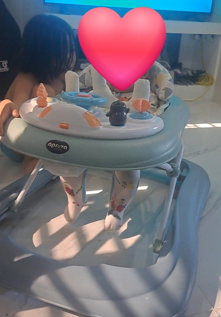 Apruva Baby Walker with Toy Tray (Category: Infant Playtime) located in Gapan. Submitted by smallfinds.ph (Listing ID 1469403623, Image 1). Description: - Brand: Apruva Baby Walker - Color: Green and Grey - Comfort: Soft padded seat with back support - Fun Features: Interactive toy tray with steering wheel and penguin toy - Safety & Design: Stable base design with a wide footrest area underneath - Ideal for: Little ones learning to walk.
