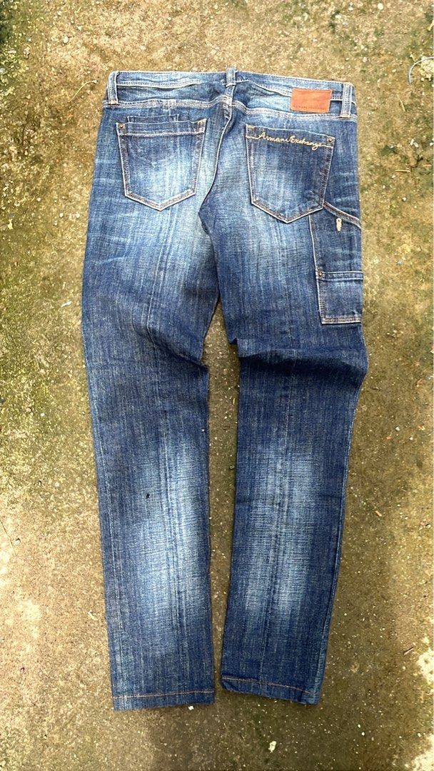Armani Exchange Denim Jeans (Category: Jeans) located in Manila. Submitted by thrifttika (Listing ID 1469448838, Image 2). Description: - Brand: Armani Exchange - Color/Wash: Medium blue wash - Design: Distressed fading pattern on front and back - Details: Classic leather brand patch on rear waistband, stylish script embroidery on back pocket, and a functional side utility loop - Closure: Button and zip fly - Condition: Excellent, ready to wear -