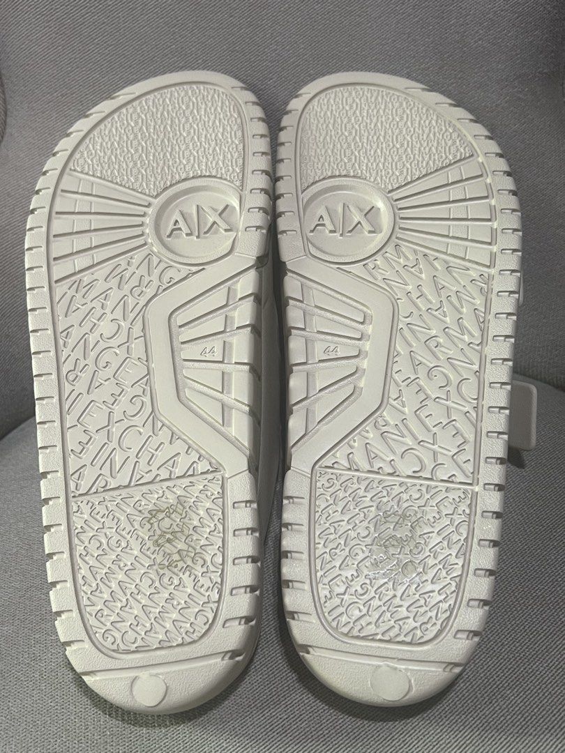 Armani Exchange Double Buckle Slides Cream Size 44 (Category: Slippers & Slides) located in Manila. Submitted by trustedceller (Listing ID 1469456657, Image 2). Description: - Brand: Armani Exchange - Style: Double buckle slides - Color: Cream/Beige - Size: 44 - Condition: Brand new with original tags attached (unworn) - Material: Synthetic upper and sole - Features: Two adjustable straps with embossed brand lettering, textured footbed with logo 