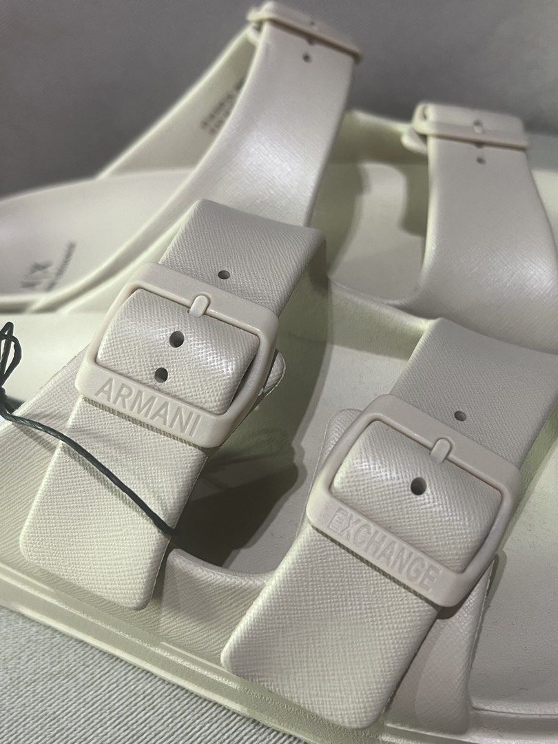 Armani Exchange Double Buckle Slides Cream Size 44 (Category: Slippers & Slides) located in Manila. Submitted by trustedceller (Listing ID 1469456657, Image 3). Description: - Brand: Armani Exchange - Style: Double buckle slides - Color: Cream/Beige - Size: 44 - Condition: Brand new with original tags attached (unworn) - Material: Synthetic upper and sole - Features: Two adjustable straps with embossed brand lettering, textured footbed with logo 