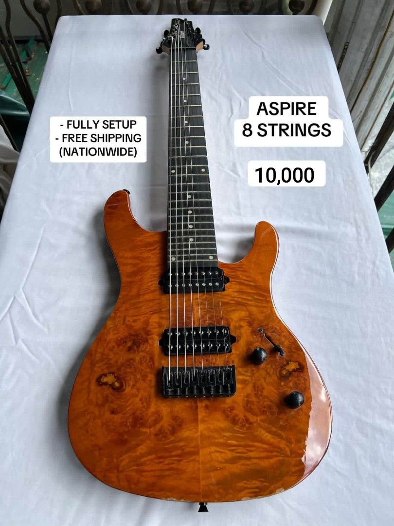 ASPIRE 8 Strings Electric Guitar (Category: Musical Instruments) located in General Santos City (Dadiangas). Submitted by jay_roa (Listing ID 1469531978, Image 1). Description: - ASPIRE 8-string electric guitar with stunning amber burl top finish - Dual humbucking pickups and fixed bridge for solid tone and stability - Clean fretboard with sleek black hardware, dual control knobs, and pickup selector switch - Fully setup and ready to play out of 