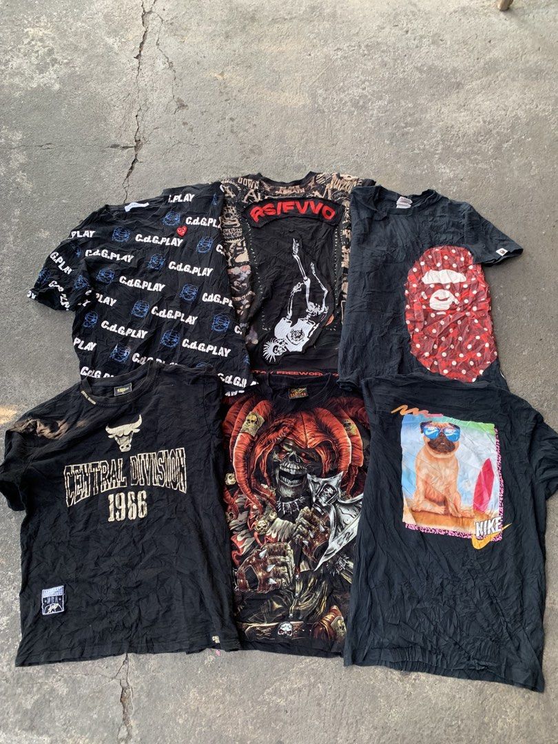 Assorted Graphic T-Shirts Bundle Streetwear Brands (Category: Tshirts & Polo Shirts ) located in Villasis. Submitted by felixpioli13956 (Listing ID 1469401323, Image 1). Description: - Bundle of popular streetwear tees including Supreme, BAPE, CDG, and Fear of God - Colors: Black, olive, grey, pink, and navy - Designs: Front and back graphic prints featuring dogs, skeletons, pugs, monkeys, and text logos - Fit: Standard short sleeve crewneck cut 