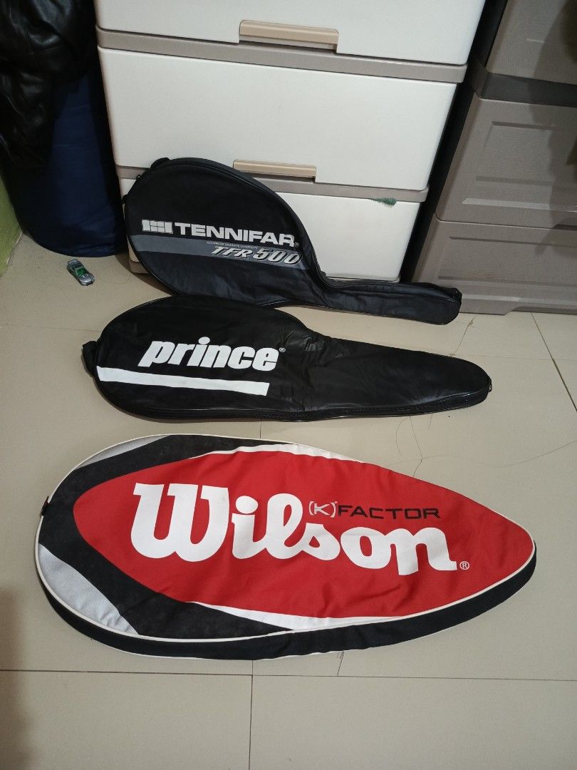 Assorted Tennis Racket Covers Wilson Prince Tennifar (Category: Racket and Ball Sports) located in Irosin. Submitted by whanchore55263 (Listing ID 1467106545, Image 3). Description: Three tennis racket covers up for grabs. Includes a red and black Wilson K Factor cover, a black Prince cover, and a black Tennifar TFR 500 cover with Japana tag inside. Solid zipper closures and soft interior lining on all three to keep rackets protected during trans
