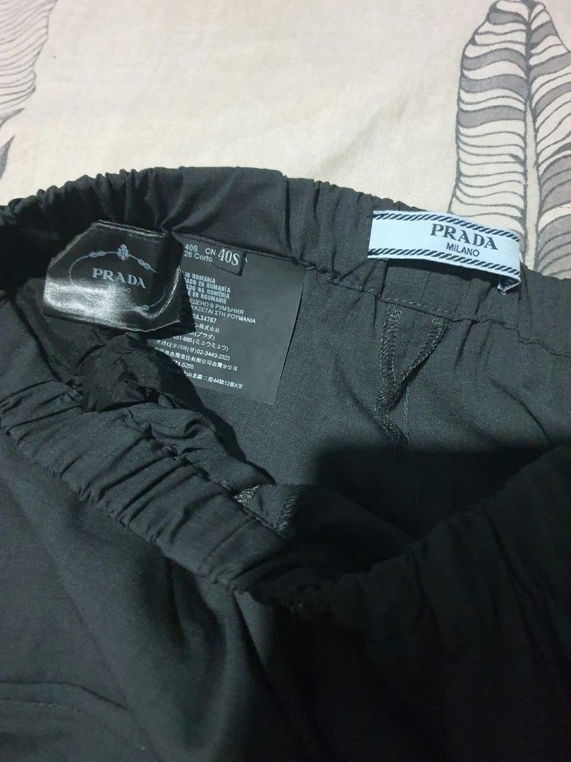 Authentic💯2pcs Prada Black Cargo Pants (Category: Luxury Apparel) located in Tagum. Submitted by maryjanepradalux (Listing ID 1469551339, Image 3). Description: - Brand: Prada (Made in Romania) - Size: 40S - Color: Black with white and yellow side stripes - Design: Multi-pocket cargo styling with zippered ankle cuffs - Details: Elastic waistband with interior Prada Milano tags - Fit: Comfortable custom streetwear piece Pm for more details .