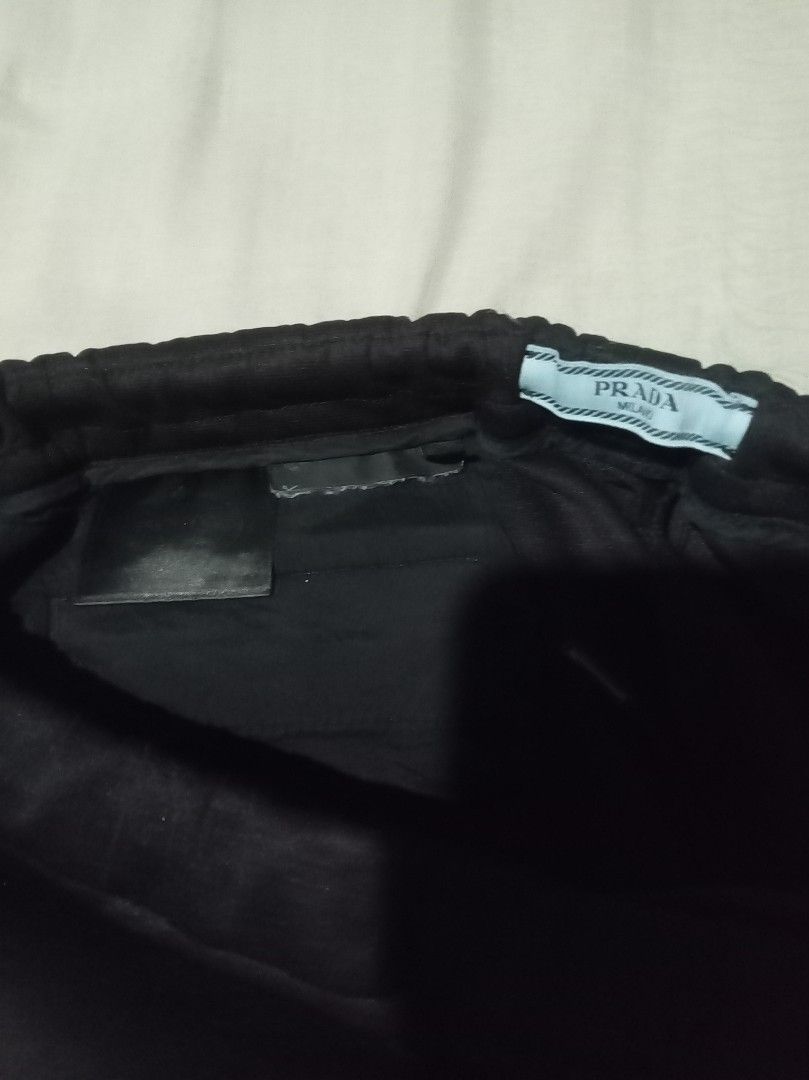 Authentic💯2pcs Prada Black Cargo Pants (Category: Luxury Apparel) located in Tagum. Submitted by maryjanepradalux (Listing ID 1469551339, Image 2). Description: - Brand: Prada (Made in Romania) - Size: 40S - Color: Black with white and yellow side stripes - Design: Multi-pocket cargo styling with zippered ankle cuffs - Details: Elastic waistband with interior Prada Milano tags - Fit: Comfortable custom streetwear piece Pm for more details .