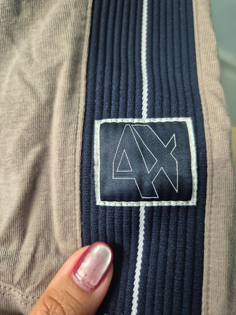 Authentic Armani Exchange Regular Fit T-Shirt Size M (Category: Tshirts & Polo Shirts ) located in Paranaque City. Submitted by monicaboo (Listing ID 1469428726, Image 3). Description: - Brand: Armani Exchange - Fit: Regular fit - Size: Medium (tag printed on inner collar) - Color: Beige / Taupe with contrasting dark navy shoulder stripes - Details: Features A|X logo patch on the shoulders, clean crew neck - Material: Comfortable cotton blend - O