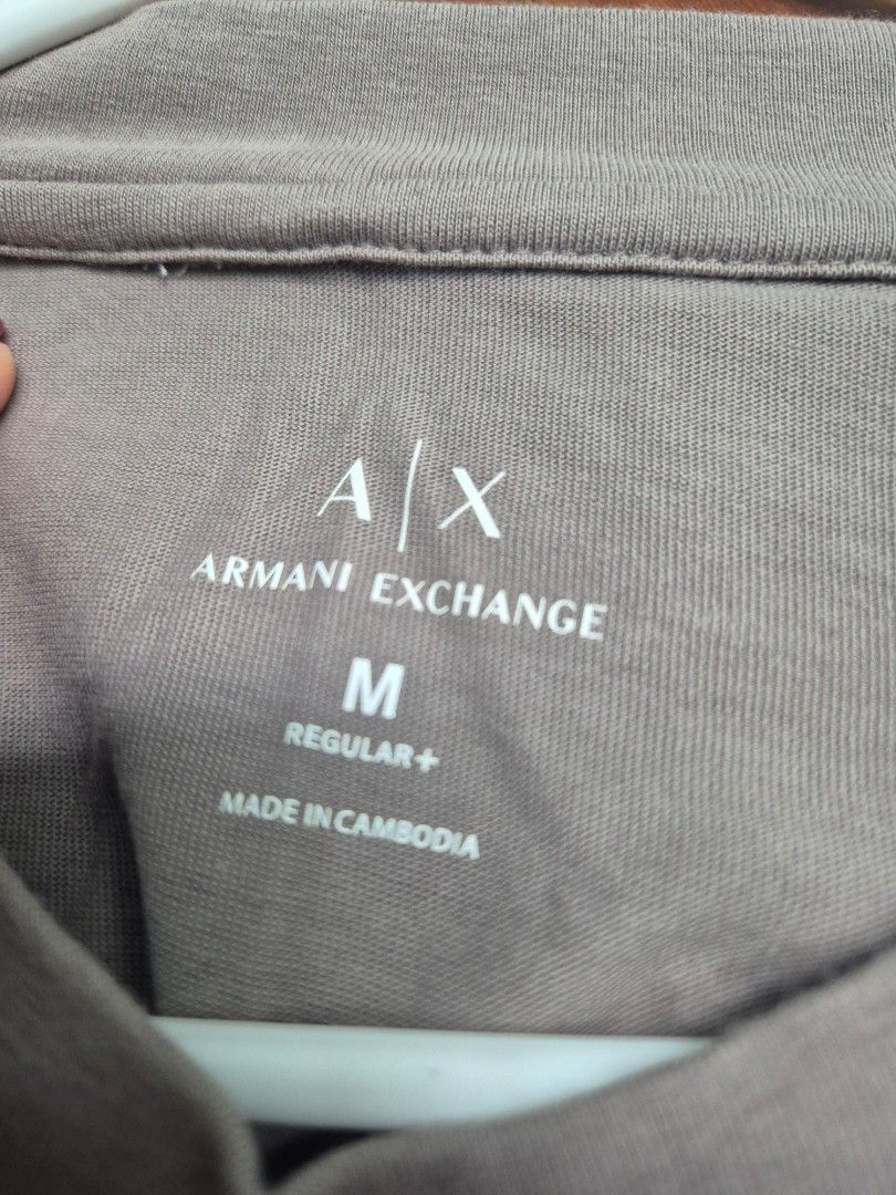 Authentic Armani Exchange Regular Fit T-Shirt Size M (Category: Tshirts & Polo Shirts ) located in Paranaque City. Submitted by monicaboo (Listing ID 1469428726, Image 2). Description: - Brand: Armani Exchange - Fit: Regular fit - Size: Medium (tag printed on inner collar) - Color: Beige / Taupe with contrasting dark navy shoulder stripes - Details: Features A|X logo patch on the shoulders, clean crew neck - Material: Comfortable cotton blend - O