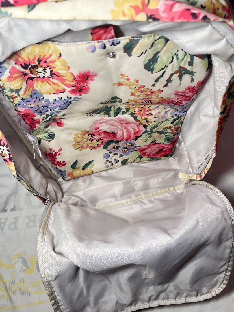 Authentic Cath Kidston Floral Print Backpack (Category: Backpacks) located in Cabuyao City. Submitted by annebueno (Listing ID 1469547123, Image 3). Description: - Brand: Cath Kidston - Design: Vintage floral print on a cream background - Material: Wipe-clean PVC coating with polyester lining - Features: Front zip pocket, dual adjustable shoulder straps, and top carry handles with snap button tab - Condition: Pre-loved with minor dirt marks near 