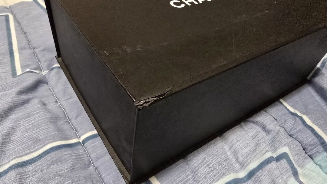 Authentic Chanel Box (from a Chanel Le Boy Old Medium (Category: Storage Boxes & Baskets) located in Las Pinas. Submitted by insouciant_worrier (Listing ID 1469556467, Image 3). Description: - Authentic black Chanel bag box featuring the classic white logo on top - Sturdy, rigid construction with a secure magnetic closure - Generous rectangular size with a clean interior - Condition: Minor surface scuffs and slight wear on one corner edge.
