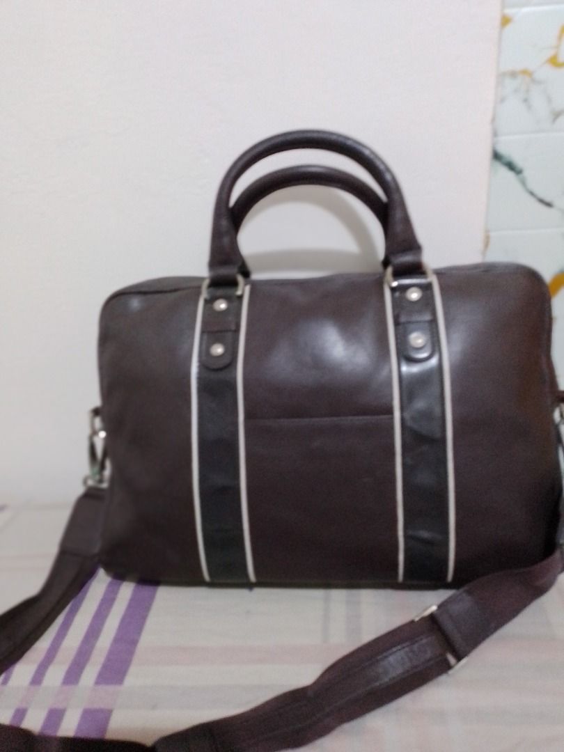 Authentic DAKS Executive Leather Laptop Bag Briefcase with Shoulder Strap (Category: Briefcases) located in Imus. Submitted by bestfinds_yeth0724 (Listing ID 1469570813, Image 2). Description: - Dark brown leather briefcase, ideal for work and daily commutes - Sturdy dual top handles with minor wear from handling - Includes an adjustable canvas shoulder strap - Secure main zip compartment with structured fabric lining - Interior includes a zipper