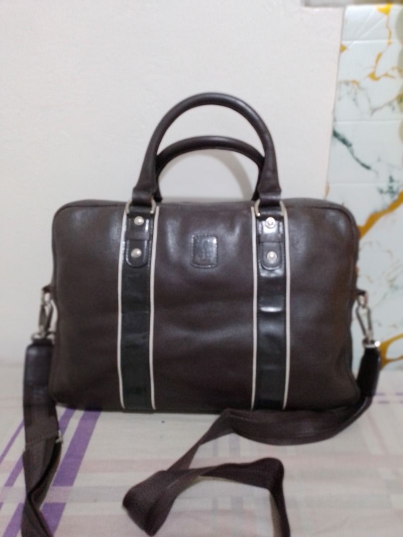 Authentic DAKS Executive Leather Laptop Bag Briefcase with Shoulder Strap (Category: Briefcases) located in Imus. Submitted by bestfinds_yeth0724 (Listing ID 1469570813, Image 1). Description: - Dark brown leather briefcase, ideal for work and daily commutes - Sturdy dual top handles with minor wear from handling - Includes an adjustable canvas shoulder strap - Secure main zip compartment with structured fabric lining - Interior includes a zipper