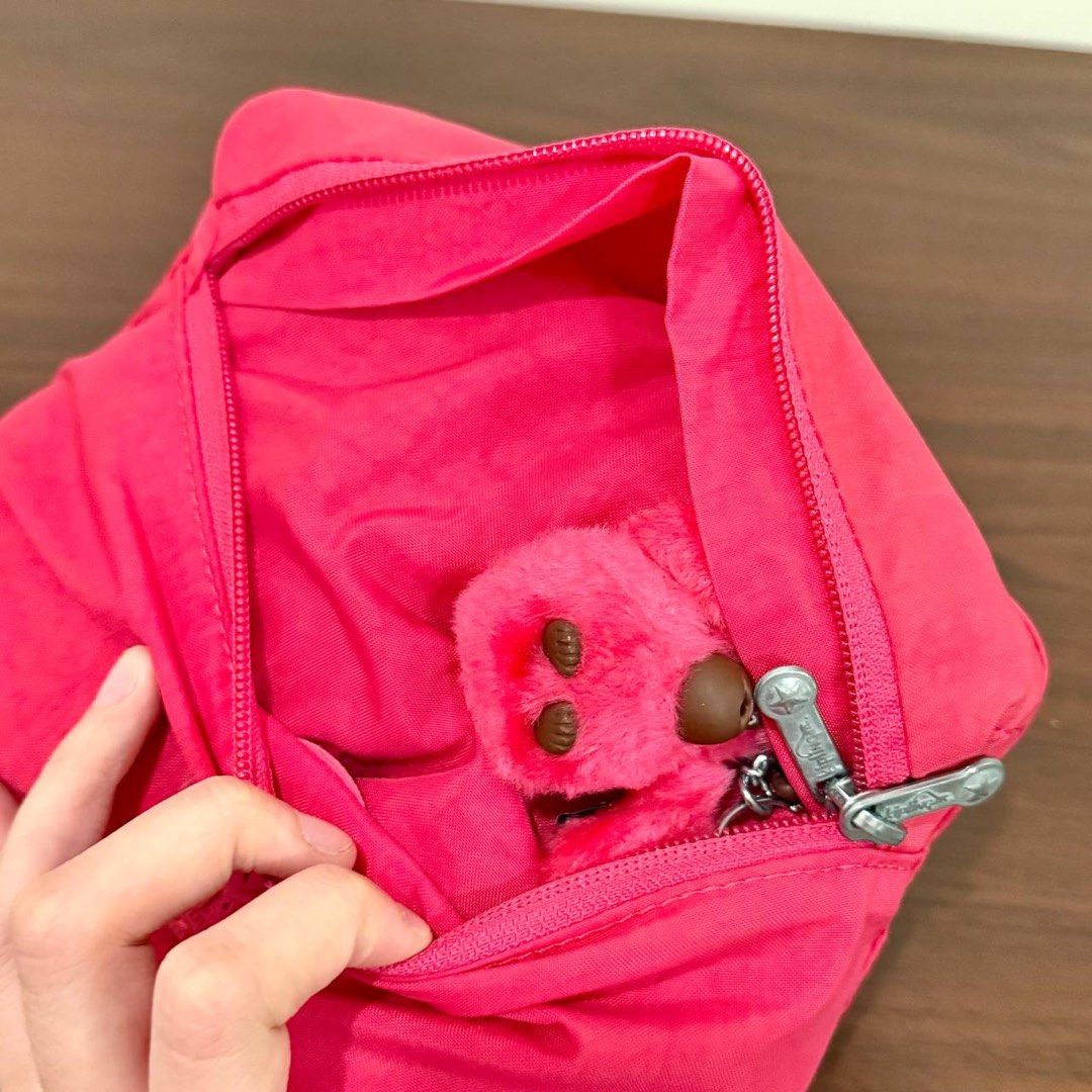 [Authentic] Kipling 2 Go Hot Pink Foldable Nylon Backpack Monkey Charm Lightweight Packable Bag (Category: Backpacks) located in Quezon City. Submitted by brandedusagoodies (Listing ID 1469558361, Image 3). Description: Kipling 2 Go fold backpack in vivid pink nylon with a rubberized Kipling logo patch on the front. It has a front zip pocket, a zip main compartment, silver-tone Kipling zipper pulls, a pink monkey keychain charm, a top carry handl