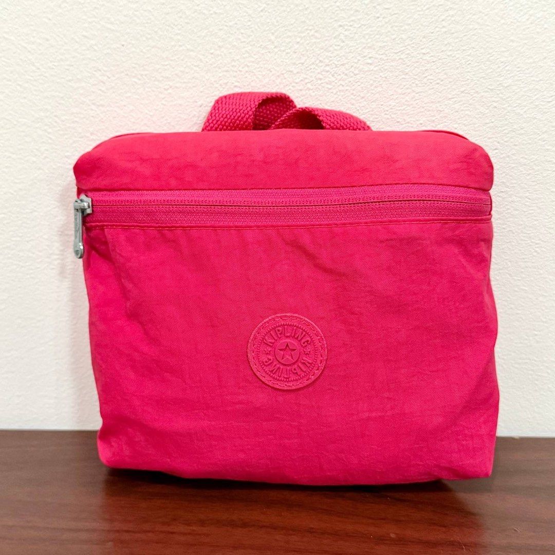 [Authentic] Kipling 2 Go Hot Pink Foldable Nylon Backpack Monkey Charm Lightweight Packable Bag (Category: Backpacks) located in Quezon City. Submitted by brandedusagoodies (Listing ID 1469558361, Image 1). Description: Kipling 2 Go fold backpack in vivid pink nylon with a rubberized Kipling logo patch on the front. It has a front zip pocket, a zip main compartment, silver-tone Kipling zipper pulls, a pink monkey keychain charm, a top carry handl
