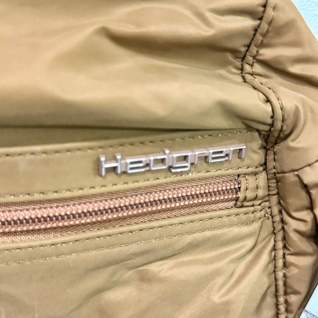 [Authentic] Used Hedgren Brown Nylon Backpack Front Zipper Pocket Keychain Lightweight Bag (Category: Backpacks) located in Quezon City. Submitted by brandedusagoodies (Listing ID 1469552081, Image 2). Description: Used Hedgren backpack in a brown color with a lightweight nylon-style exterior, metallic brand logo, and signature Hedgren keychain charm. It features a front zippered pocket, side pockets, adjustable shoulder straps, and a spacious ma