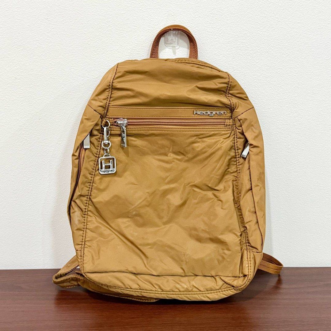 [Authentic] Used Hedgren Brown Nylon Backpack Front Zipper Pocket Keychain Lightweight Bag (Category: Backpacks) located in Quezon City. Submitted by brandedusagoodies (Listing ID 1469552081, Image 1). Description: Used Hedgren backpack in a brown color with a lightweight nylon-style exterior, metallic brand logo, and signature Hedgren keychain charm. It features a front zippered pocket, side pockets, adjustable shoulder straps, and a spacious ma