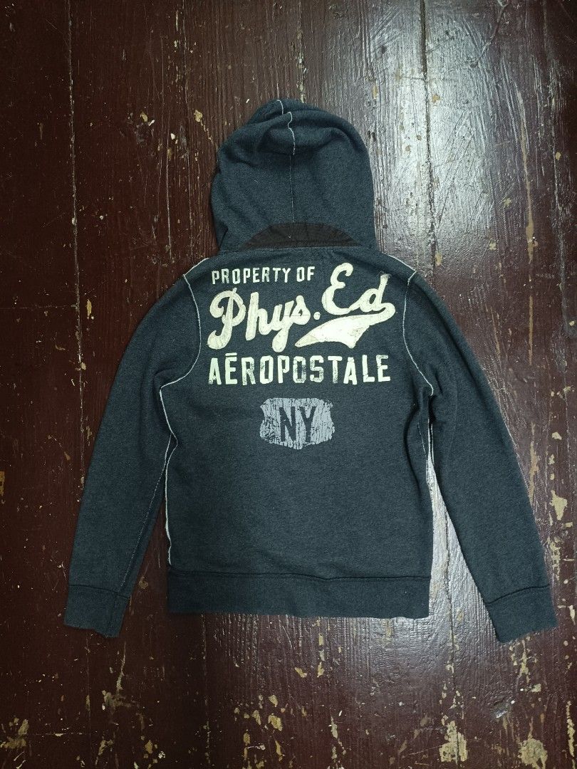 AUTHENTIC VINTAGE AĒROPOSTLE (Category: Coats, Jackets and Outerwear) located in Manila. Submitted by cluhhh (Listing ID 1469541778, Image 2). Description: Details: Brand: AÉROPOSTALE Size: M (Medium) Width - 22 Length- 29 selling for 699 + 15 shipping fee Color: Charcoal Gray Style: Vintage / Y2K / Casual Streetwear Design: Front embroidered-style appliqué and distressed back graphics Features: Hooded pullover, kangaroo pocket, button neckline, 