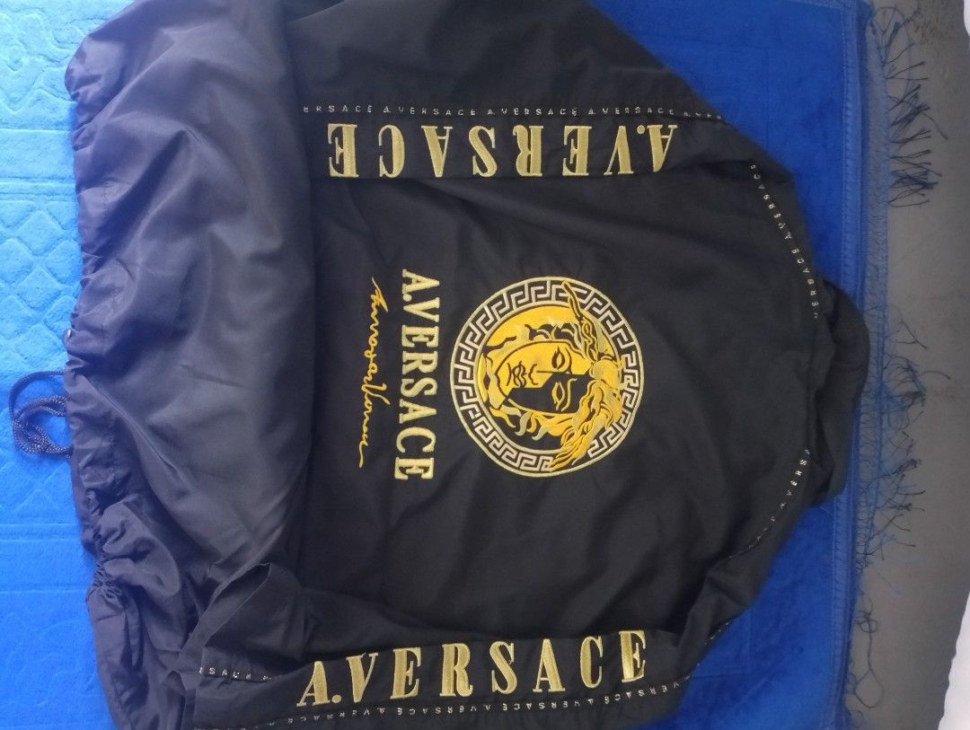 AV By Aversace Diffusion Black Gold Jacket Size M (Category: Coats, Jackets and Outerwear) located in Manila. Submitted by wonderboi80 (Listing ID 1469400021, Image 2). Description: - Brand: AV By Aversace Diffusion - Color: Black with bold gold embroidery on chest, back, and sleeves - Size: Medium (true to size) - Material: 100% nylon outer shell with breathable camo mesh inner lining - Features: Full front zipper, stand-up collar, and adjustabl