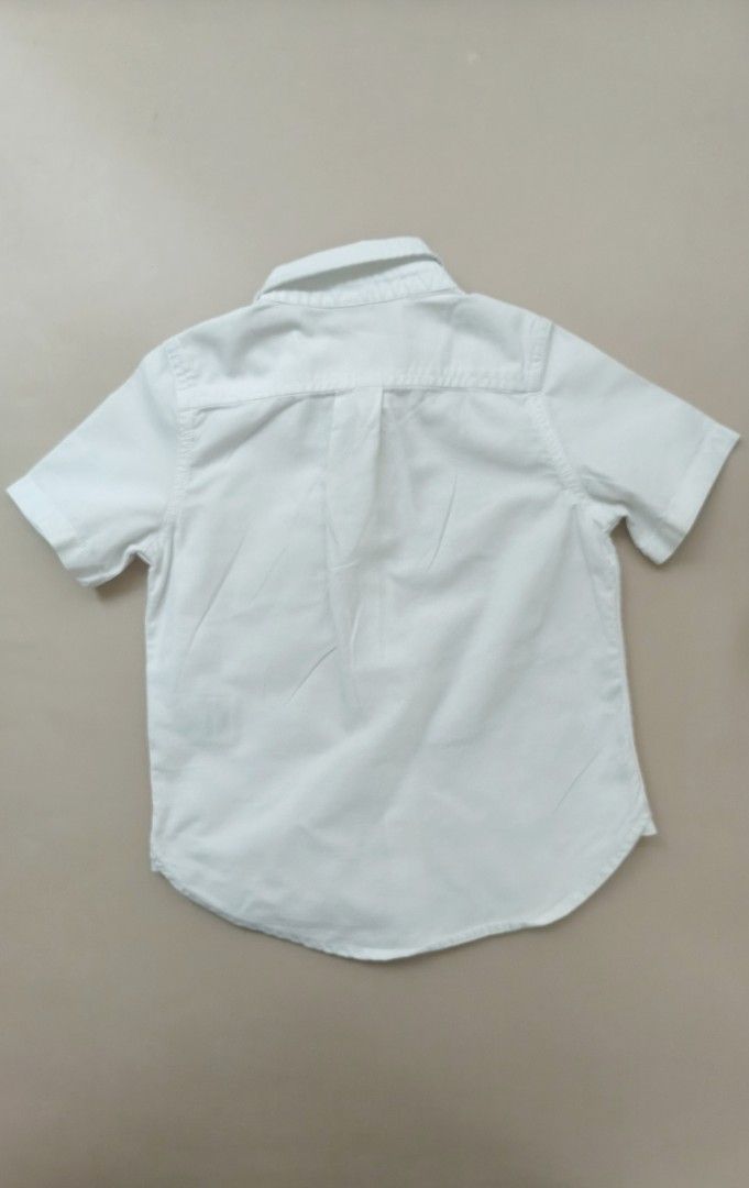 Baby Gap White Short Sleeve Button Down Shirt 3yo (Category: Babies & Kids Fashion) located in Cebu City. Submitted by little_mush.room (Listing ID 1469452223, Image 3). Description: - Brand: Baby Gap - Size: 3 Years (Toddler) - Color: Classic White - Material: Soft Cotton - Details: Short sleeves, button-down front, classic collar, chest pocket with cute embroidered bear, and curved back hem - Condition: Clean and ready to wear.
