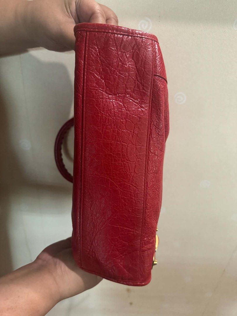 Balenciaga City Bag Red Leather (Category: Luxury Bags & Wallets) located in Balagtas. Submitted by momandkidstuffph (Listing ID 1469410013, Image 3). Description: - Brand: Balenciaga - Color: Bright Red with Gold-tone hardware - Material: Distressed crinkled leather - Features: Front zip pocket, top zip closure, double top handles, and side tassel detail - Condition: Clean interior and corners, well-maintained timeless style.