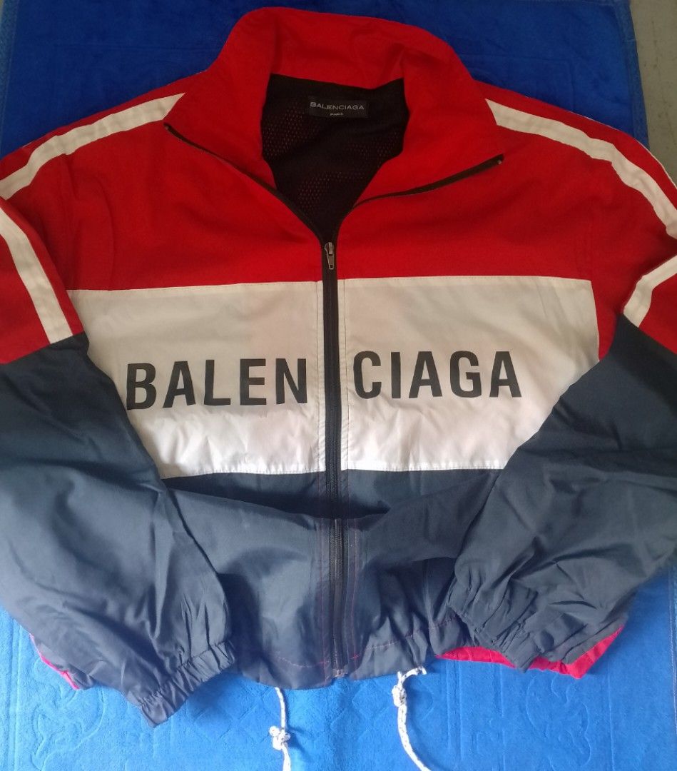 Balenciaga Colorblock Windbreaker Jacket (Category: Coats, Jackets and Outerwear) located in Manila. Submitted by wonderboi80 (Listing ID 1469401634, Image 1). Description: - Brand: Balenciaga - Design: Bold colorblock (Red, White, Dark Blue) with vertical front logo - Features: Full zip closure, stand collar, breathable mesh lining - Fit: Adjustable drawstring hem and elastic cuffs - Origin: Made in Portugal - Condition: Premium streetwear piece