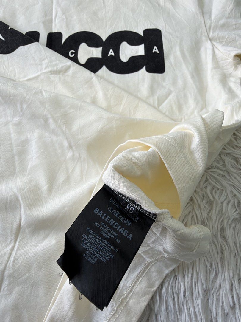 Balenciaga x Gucci (Category: Tshirts & Polo Shirts ) located in Pasig City. Submitted by dabeee07 (Listing ID 1469412322, Image 3). Description: - Brand: Balenciaga x Gucci The Hacker Project - Color: cream with black Gucci logo overlay and white Balenciaga text - Size: XS (interior tag) - Material: Premium cotton - Origin: Made in Portugal - Design: Classic crew neck, short sleeve - Fit: Can be worn oversized or regular depending on styling.