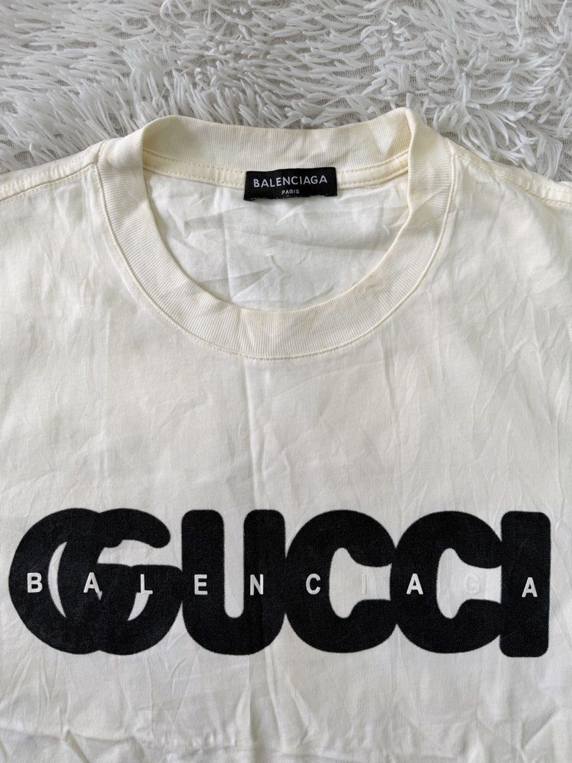 Balenciaga x Gucci (Category: Tshirts & Polo Shirts ) located in Pasig City. Submitted by dabeee07 (Listing ID 1469412322, Image 2). Description: - Brand: Balenciaga x Gucci The Hacker Project - Color: cream with black Gucci logo overlay and white Balenciaga text - Size: XS (interior tag) - Material: Premium cotton - Origin: Made in Portugal - Design: Classic crew neck, short sleeve - Fit: Can be worn oversized or regular depending on styling.