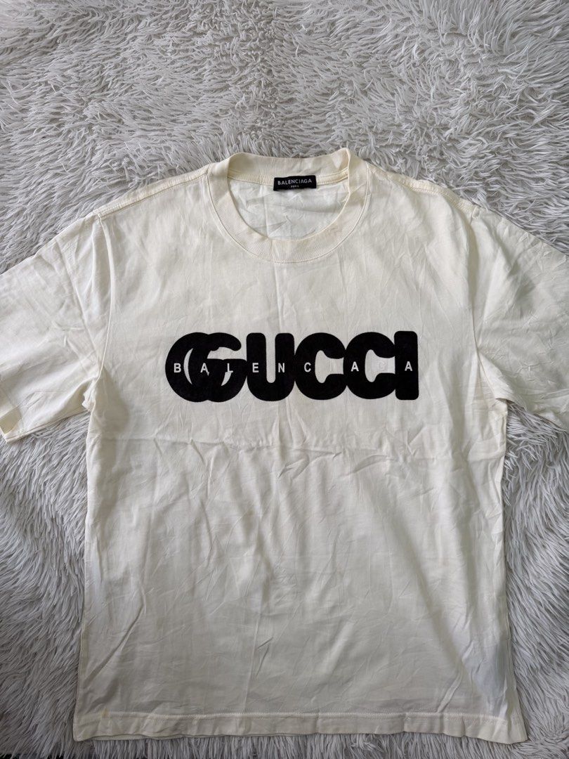 Balenciaga x Gucci (Category: Tshirts & Polo Shirts ) located in Pasig City. Submitted by dabeee07 (Listing ID 1469412322, Image 1). Description: - Brand: Balenciaga x Gucci The Hacker Project - Color: cream with black Gucci logo overlay and white Balenciaga text - Size: XS (interior tag) - Material: Premium cotton - Origin: Made in Portugal - Design: Classic crew neck, short sleeve - Fit: Can be worn oversized or regular depending on styling.