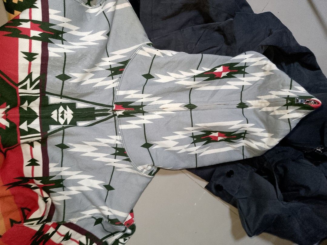BAPE Aztec Geometric Pattern Full Zip Hoodie (Category: Hoodies) located in Manila. Submitted by mjthrifted_second (Listing ID 1469409384, Image 3). Description: - Brand: BAPE (A Bathing Ape) - Design: Bold aztec geometric pattern across front, back, and sleeves -Dimes: 22/27.5 - Colorway: Grey hood, red/yellow midsection, and dark green ribbing - Details: Signature Ape head graphic integrated into the sides - Closure: Full zip up to the chin - C
