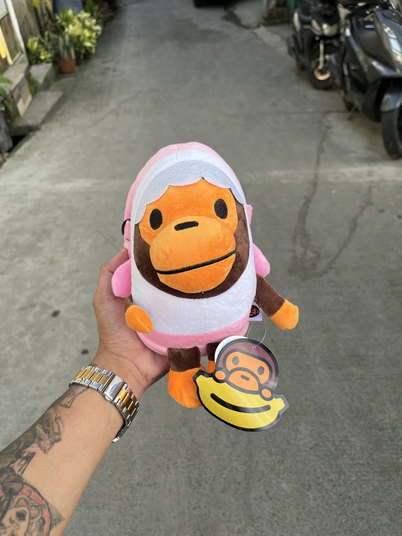 BAPE Baby Milo Plush Toy Collection (Category: Plushies & Soft Toys) located in Manila. Submitted by donthriftph. (Listing ID 1469469024, Image 1). Description: - Set of 4 authentic Baby Milo plush toys - Includes 4 designs: Pink shark hoodie, blue shark hoodie, holding a red heart, and eating a donut - All plushies come with original banana hang tags still attached - Material is ultra-soft, clean, and in pristine condition - Zero stains, flaws, 