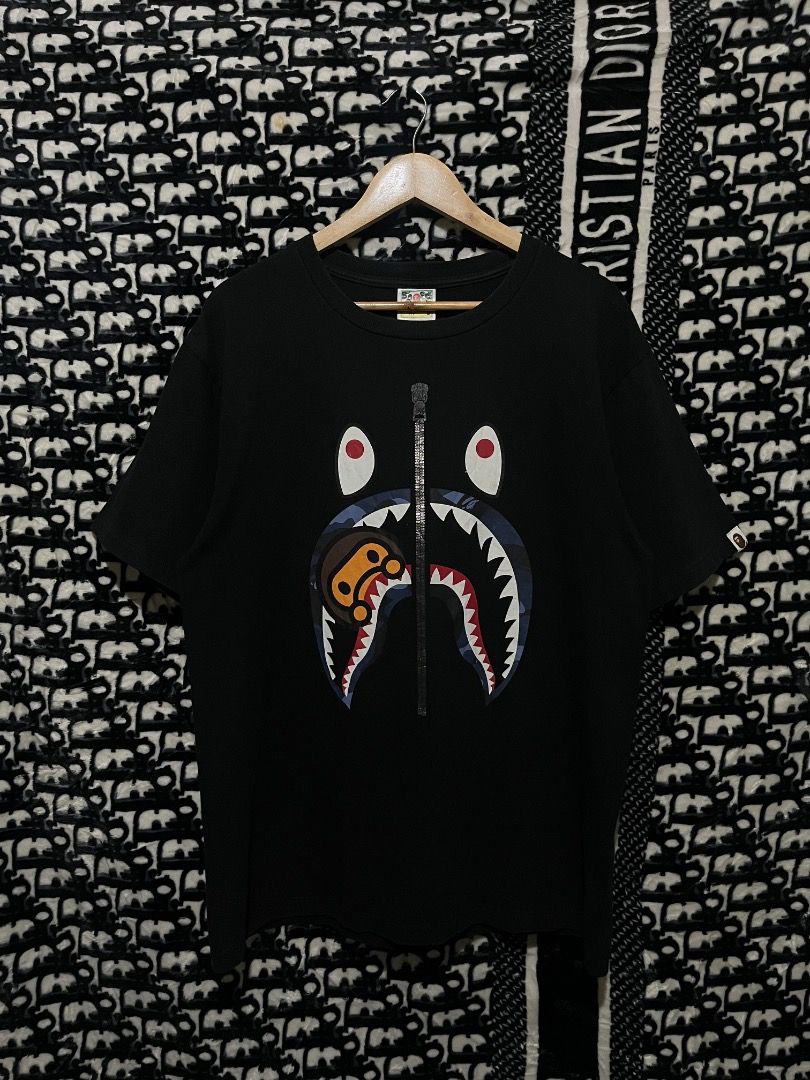 BAPE Shark Tee Black (Category: Tshirts & Polo Shirts ) located in Valencia. Submitted by vncnttroy (Listing ID 1469440187, Image 1). Description: - Authentic - Brand: BAPE (A Bathing Ape) - Item: Shark Graphic T-Shirt - Color: Solid Black - Size: Large - Details: Iconic center shark face print, Baby Milo inside the mouth, left cuff sleeve tag, and classic crewneck cut - Condition: Excellent, clean graphic with no fading - 21 x 28.