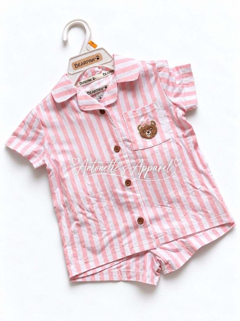 Bearpaw Pink White Striped Button Up 2PC set (Category: Babies & Kids Fashion) located in Munoz. Submitted by antonettesapparel (Listing ID 1469558369, Image 1). Description: - Brand: Bearpaw - Design: Pink and white striped short sleeve set - Condition: Brand new with branded neck tags and original hanger - Perfect for lounging and gifting! BEARPAW STRIPE SLEEPWEAR SET ₱395 only Available size: 18m 24m 2T.