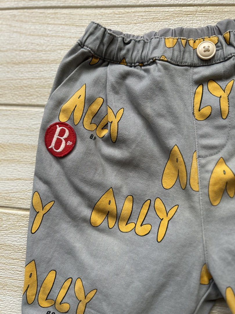 Bebedepino trousers (Category: Babies & Kids Fashion) located in Cebu City. Submitted by yjainani (Listing ID 1469409190, Image 2). Description: pair of grey children's trousers featuring an all-over yellow "ALLY" text print .