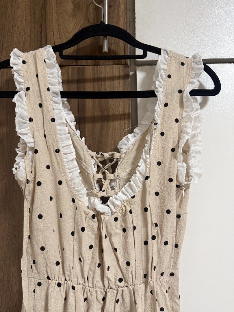 Beige Polka Dot Ruffle Maxi Dress (Category: Dresses) located in Binangonan. Submitted by curatedbyjuys (Listing ID 1469441329, Image 2). Description: - Color/Pattern: Beige with all-over black polka dots - Design details: White ruffled trim on neckline and straps with a front lace-up closure - Fit & Closure: Convenient side zipper closure - Hemline: Long, flared style with a ruffled bottom edge - Condition: Brand new / Excellent quality - Mode o