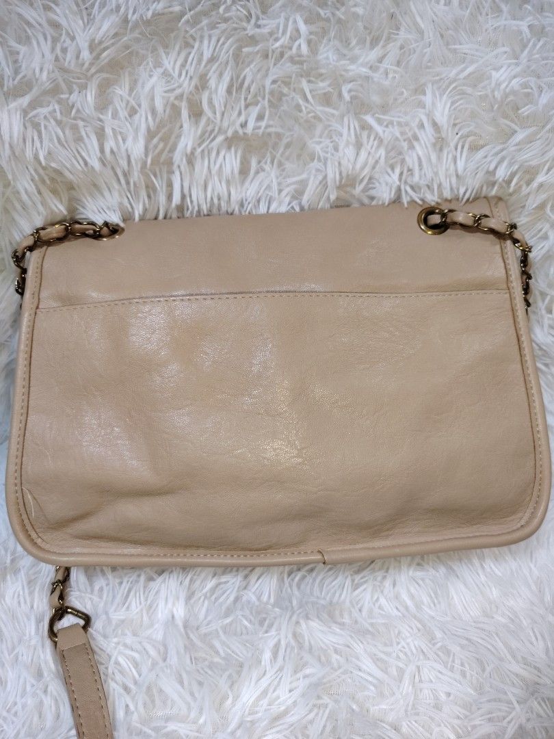 Beige shoulder bag with chain strap and gold BB clasp (Category: Cross-body Bags) located in Quezon City. Submitted by zhelcloset01 (Listing ID 1469505708, Image 2). Description: - Style: Beige leather-look shoulder bag - Closure: Flap top with gold-tone double B metal clasp - Strap: Intertwined chain and leather in matching beige - Interior: Fabric-lined with a zippered pocket divider - Exterior: Back slip pocket for quick access - Details: Soft